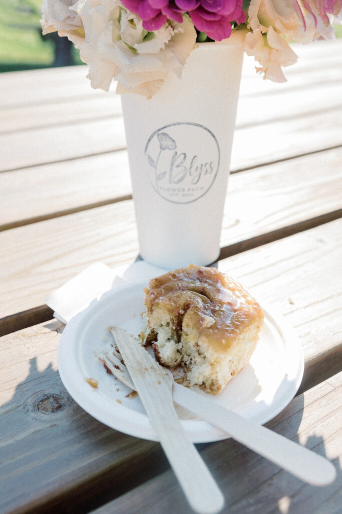 A caramel roll and a bouquet of flowers from Blyss Flower Farm
