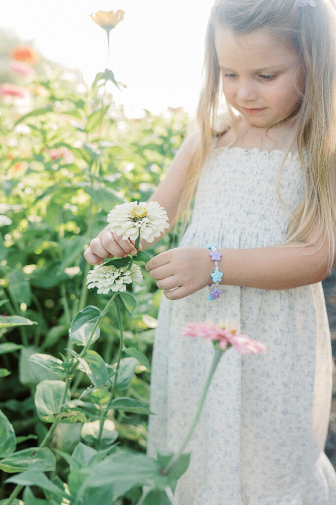 A young girl exploring the flower fields during her photo session with Chelsea Nichole Photography