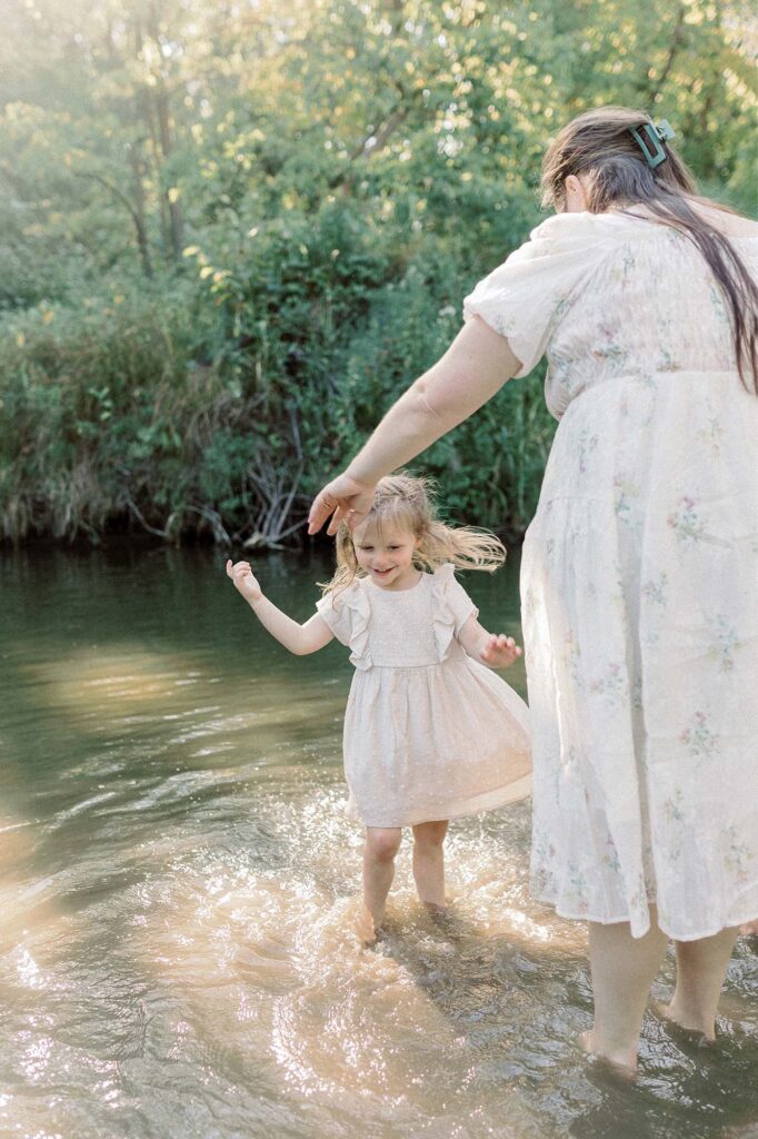 A mother and daughter playing in the river during their session with Chelsea Nichole Photography 