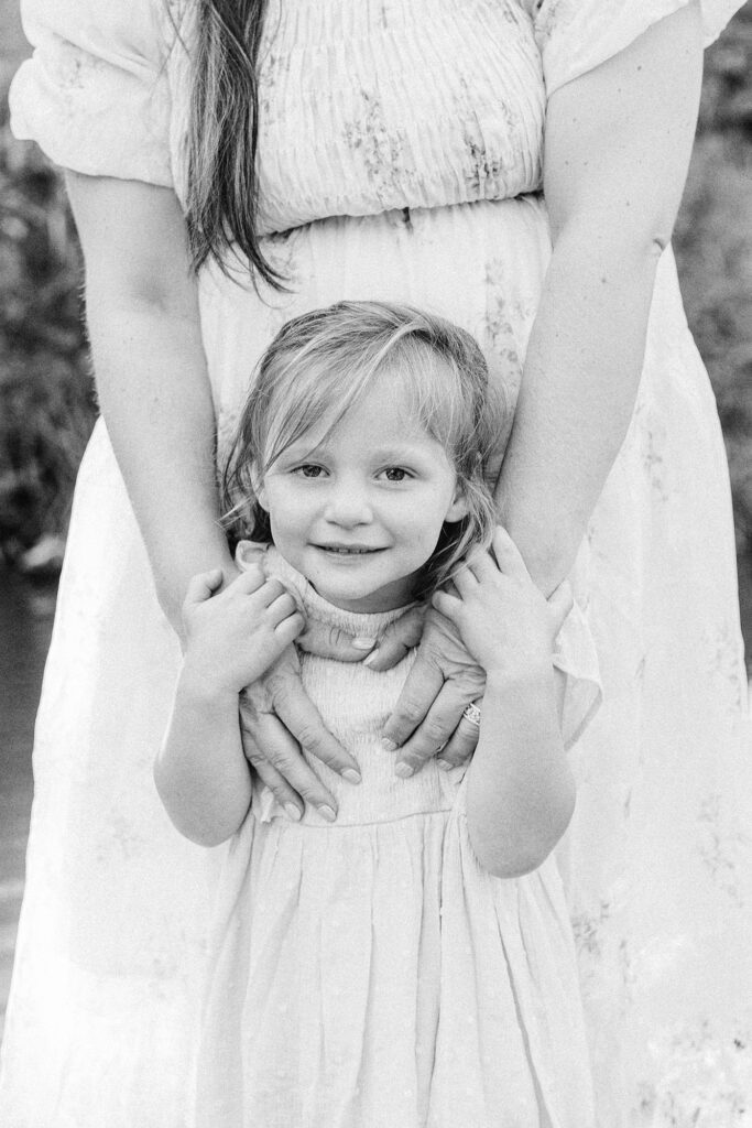 A close up of a little girl in her mom's arms during her family photo session with Chelsea Nichole Photography