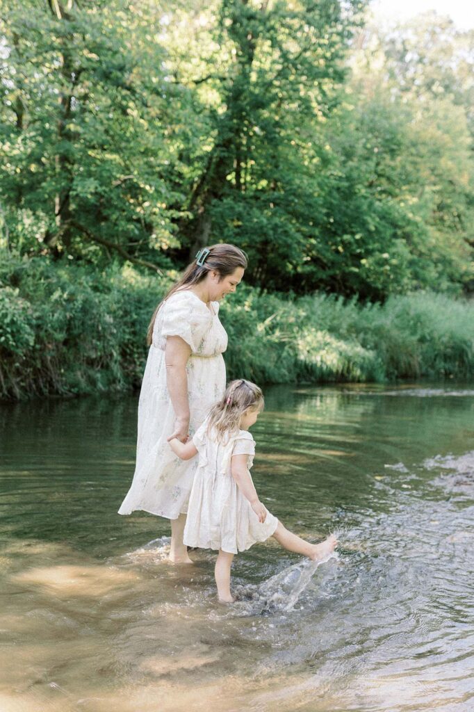 A mom and her young daughter playing in the water in Grand Forks, ND
