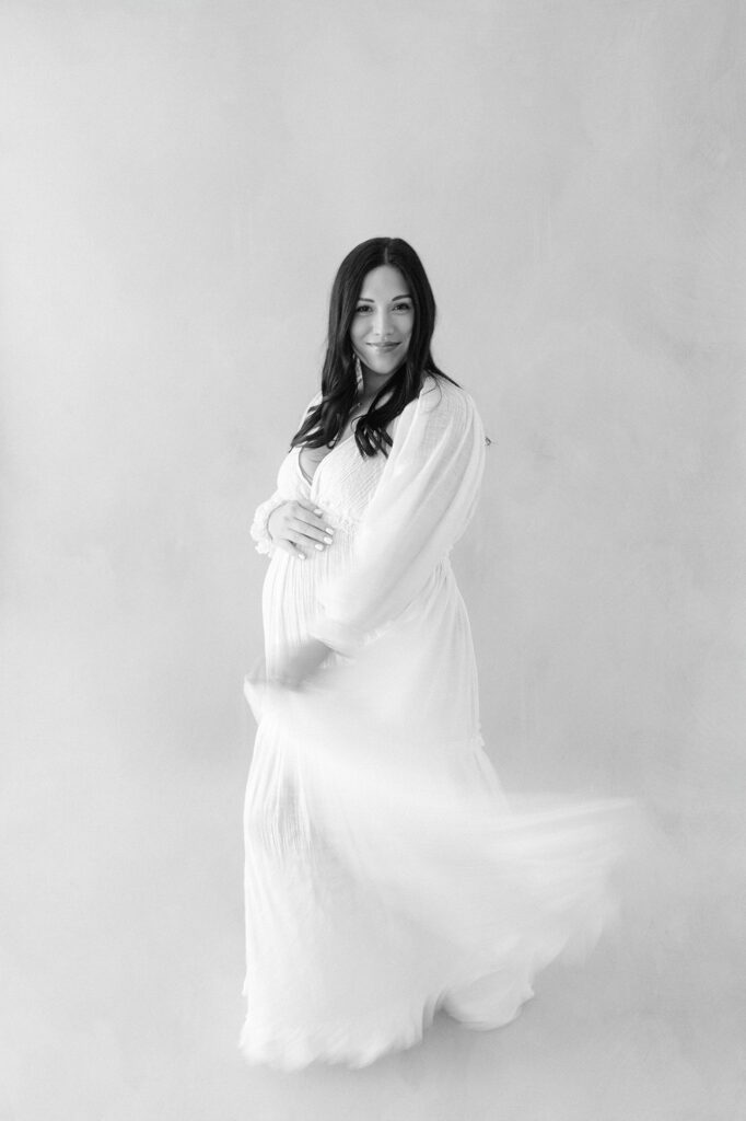 Minimal, light-filled maternity photography captured indoors in Grand Forks.