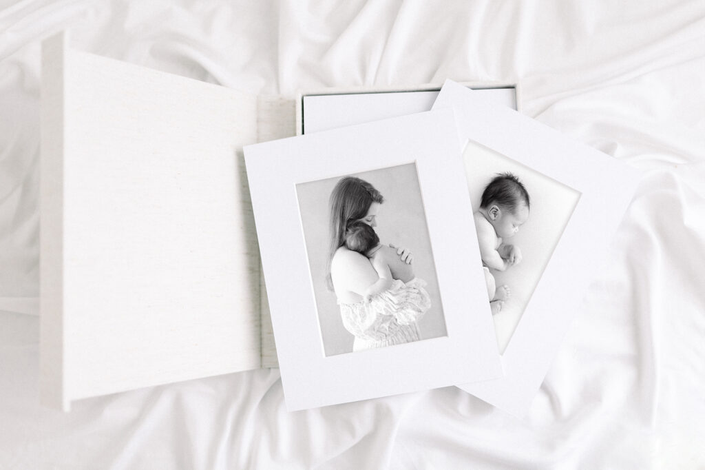 Printed photos of a mom holding a baby from their photographer in Grand Forks, ND.