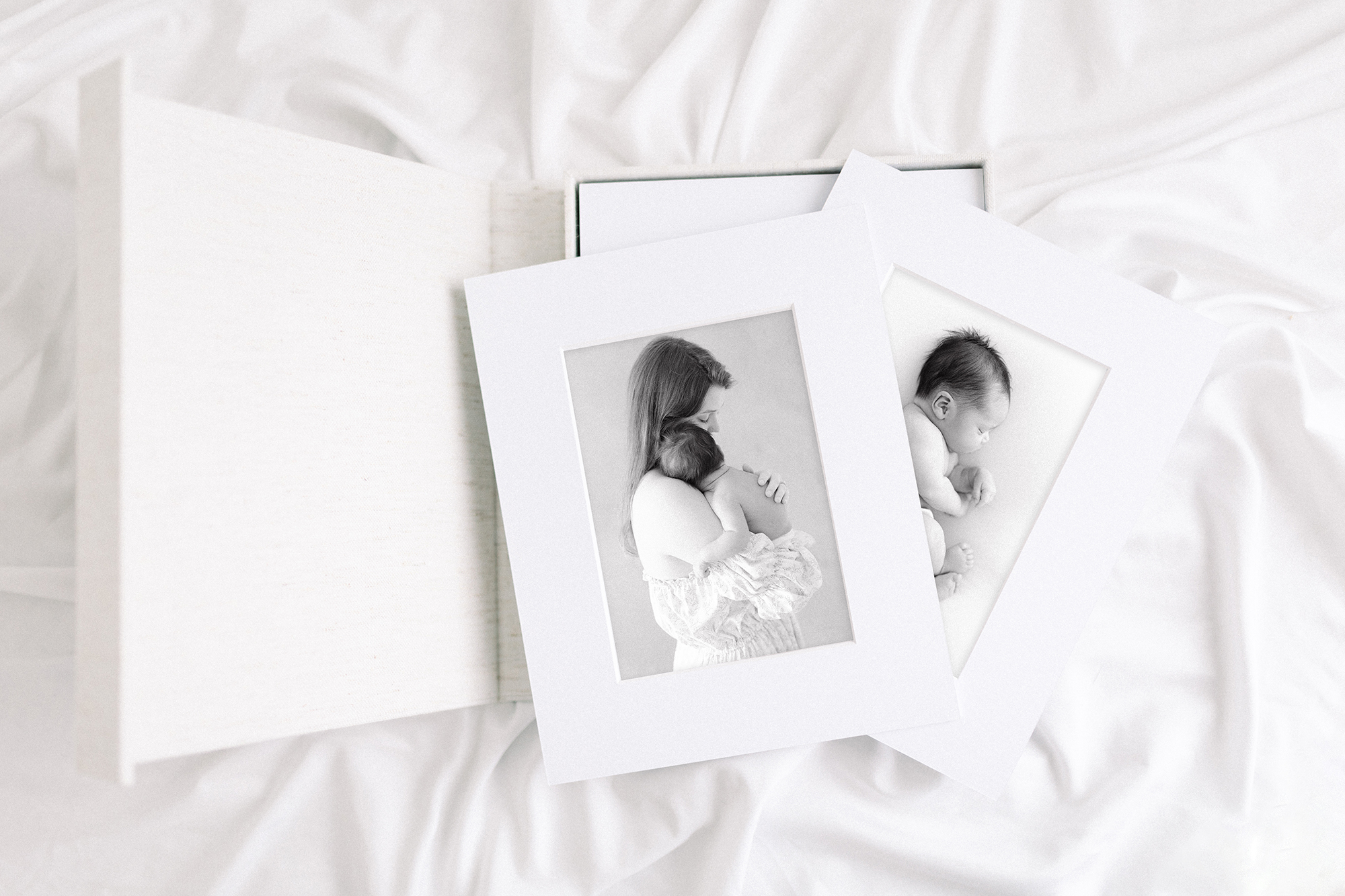 Printed photos of a mom holding a baby from their photographer in Grand Forks, ND.