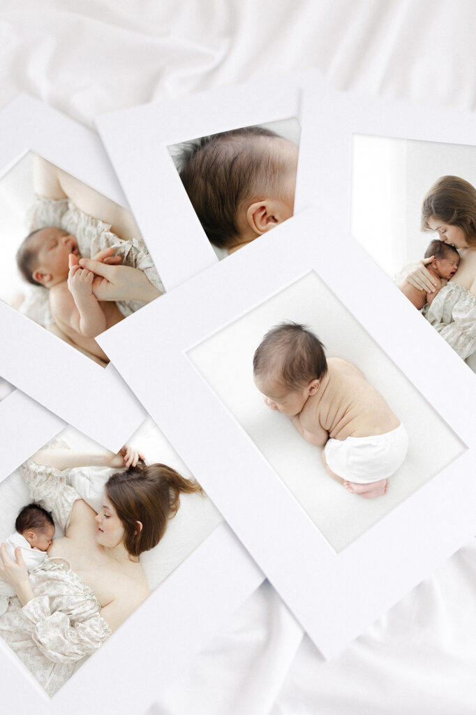 A pile of printed newborn photos spread out from a photographer in Grand Forks, ND.
