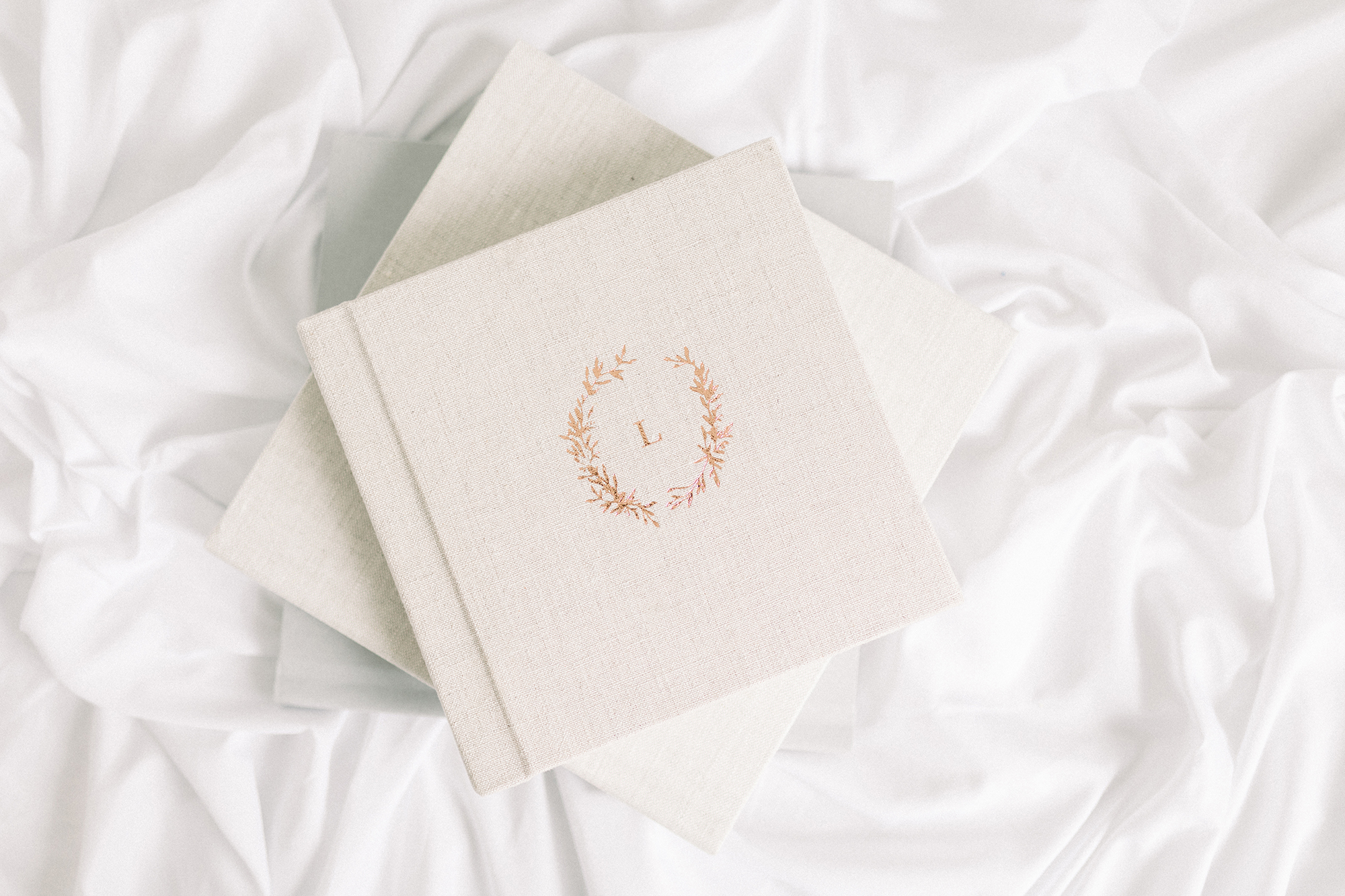 A bird's eye view of a 10x10 photo album with a linen cover.