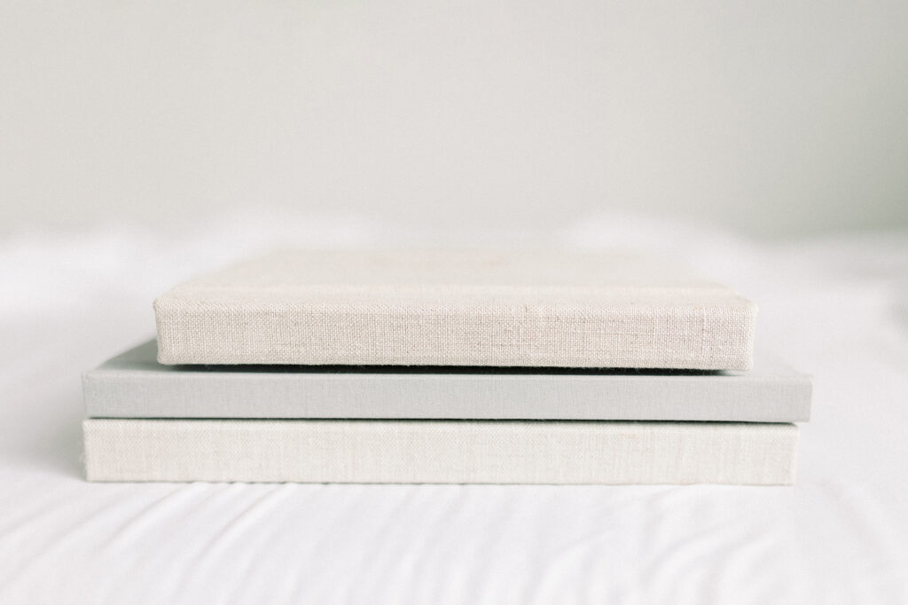 A stack of three photo albums.