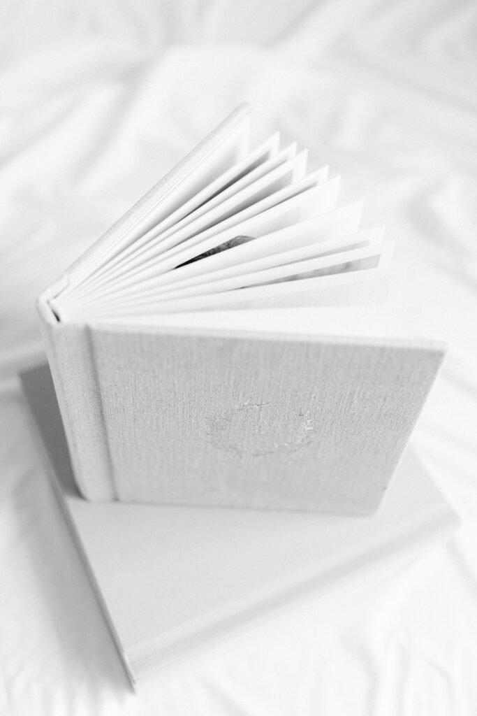 A custom photo album with images showing maternity photography in grand forks nd.