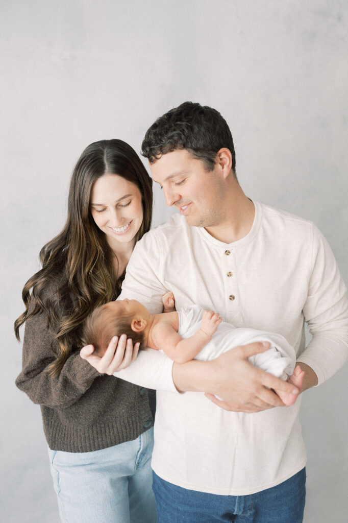 Newborn photography pose showing connection between parents and baby