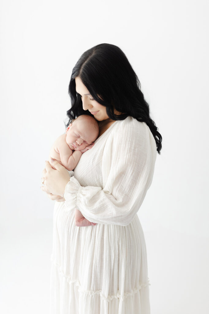 Newborn photography pose capturing connection between mother and baby