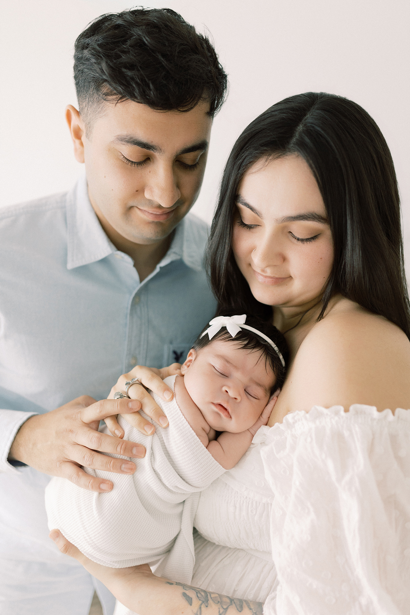 New family of three with their newborn baby girl during a Fargo newborn photography session.